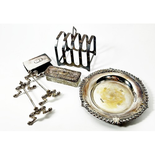 289 - A silver card tray, 14 cm diameter, together with a silver toast rack, a pair of silver knife rests,... 