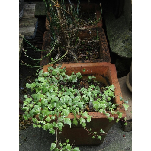 1003 - A weathered terracotta squat oviform garden planter, 34 cm high x 55 cm diameter together with three... 