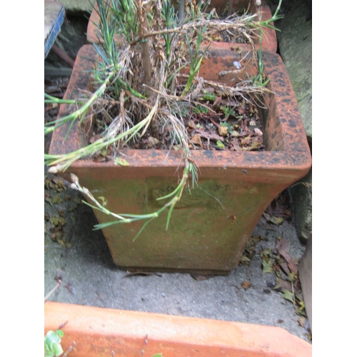 1003 - A weathered terracotta squat oviform garden planter, 34 cm high x 55 cm diameter together with three... 