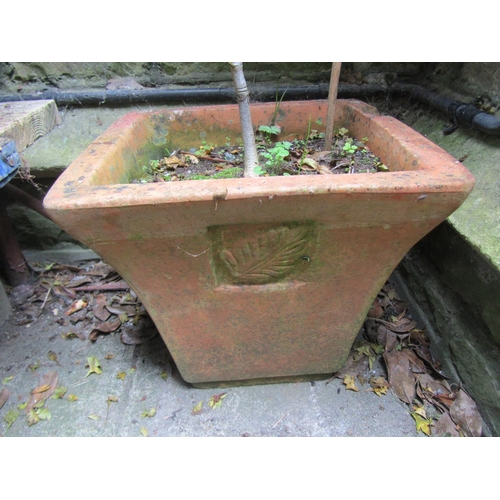 1003 - A weathered terracotta squat oviform garden planter, 34 cm high x 55 cm diameter together with three... 