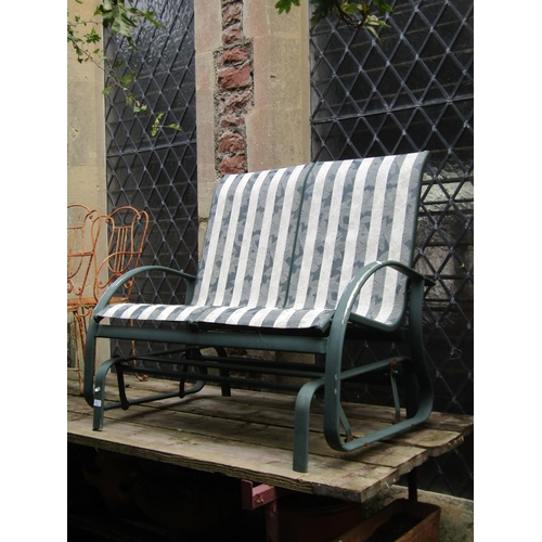 1006 - A green painted light metal framed two seat swing garden bench, 110 cm wide