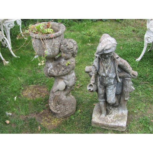 1057 - A weathered cast composition stone garden water feature in the form of a boy standing beside a rusti... 