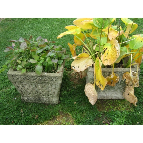 1065 - A pair of weathered composition stone planters of tapering squared form with Celtic knot moulded det... 