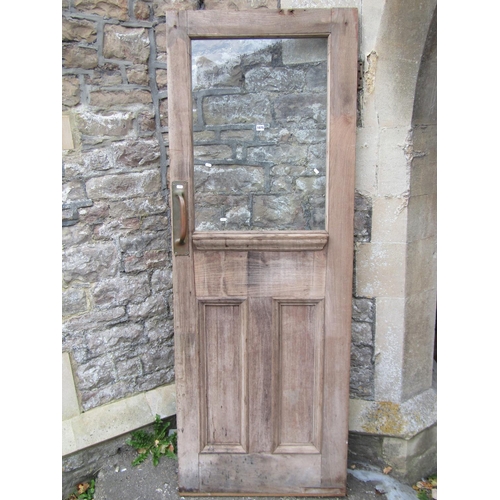 1075 - An reclaimed stripped and weathered hardwood partially glazed panelled door, 208cm high x 76cm wide