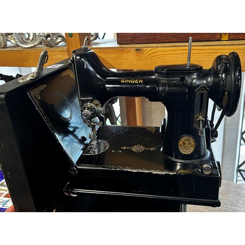 664 - An electric Singer 221k sewing machine and accessories housed in it’s original carry case.