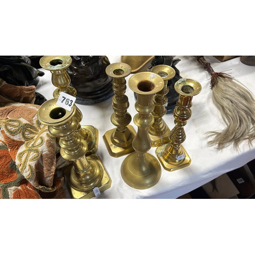 763 - A small collection of six 19th century polished brass candlesticks.