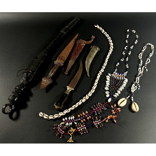 739 - A mixed collection of Asian knives, daggers together with Papua New Guinea shell and bead necklaces,... 