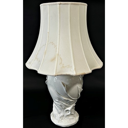 745 - A white porcelain art nouveau style table lamp with female and floral decoration, with pleated shade... 