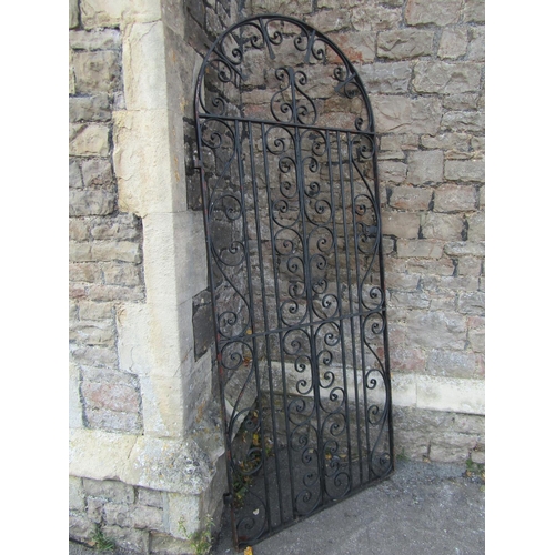 1076 - A vintage heavy gauge ironwork pedestrian side gate of arched form with decorative scroll work detai... 