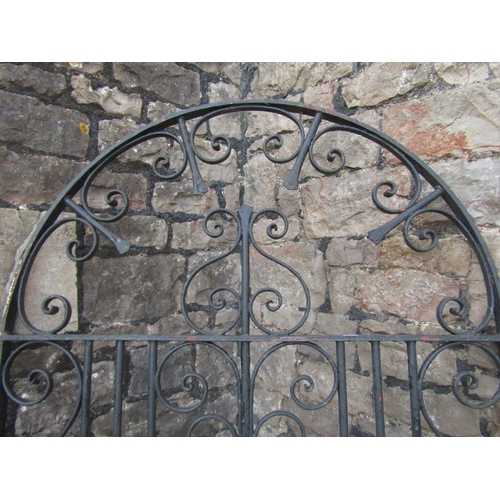 1076 - A vintage heavy gauge ironwork pedestrian side gate of arched form with decorative scroll work detai... 