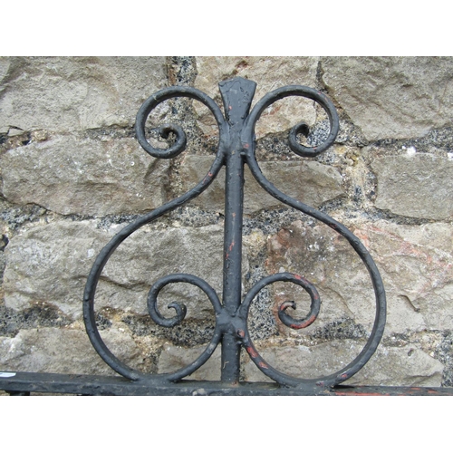 1076 - A vintage heavy gauge ironwork pedestrian side gate of arched form with decorative scroll work detai... 