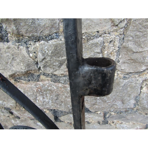 1076 - A vintage heavy gauge ironwork pedestrian side gate of arched form with decorative scroll work detai... 