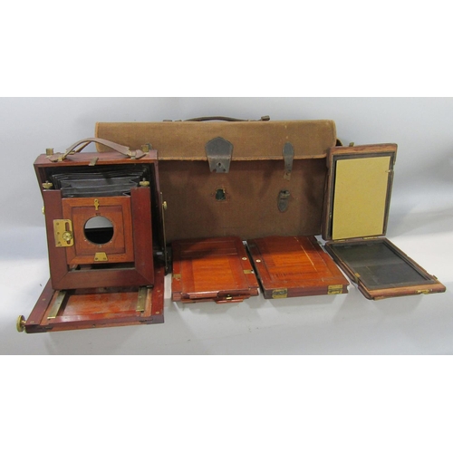 730 - An early mahogany and brass bellows camera with three mahogany plate, folds into the accompanying ca... 