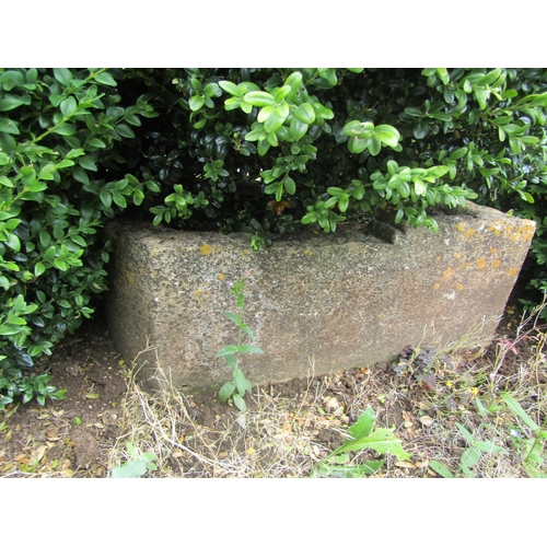 1081 - A large weathered natural stone planter of rounded squared form, with a well established box topiary... 