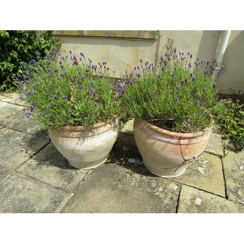 1082 - pair of weathered terracotta planters of tapering form with fluted collars, (one severely damaged) e... 