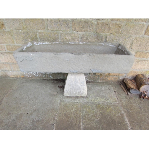 1083 - A weathered natural stone planter / trough of rectangular form raised on an an associated staddle ba... 