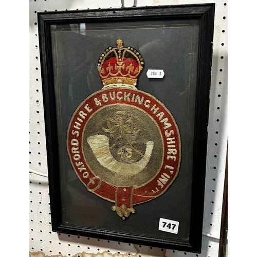 747 - A wool work panel of the Oxfordshire & Buckinghamshire L’ Inf ty, framed and glazed. 38cm x 27cm