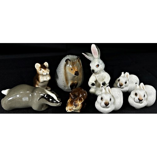 12 - A collection of Russian and other ceramic woodland characters including racoon, deer, badger, hedgeh... 