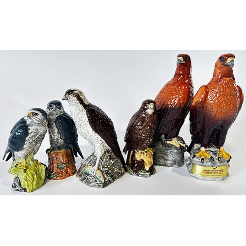 35 - A collection Beswick Beneagles, Peter Thomson Scotch Whiskey Birds of Prey flasks in various sizes (... 