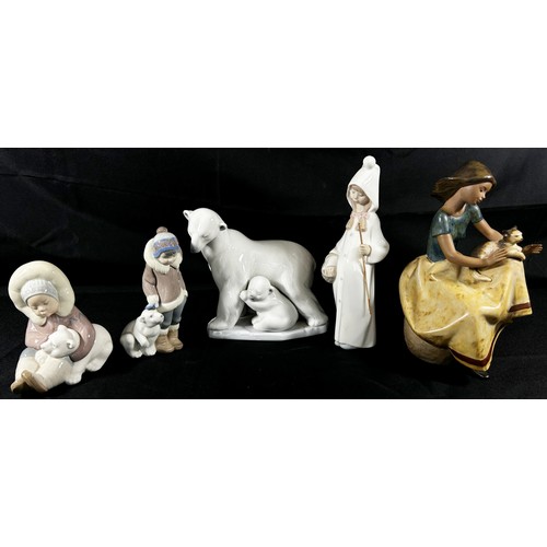 38 - A collection of Lladro figures including a coloured example of a girl with cat, no 2169, further pol... 