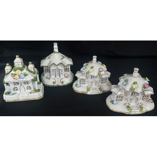 58 - A collection of four Coalport pastel burner cottages