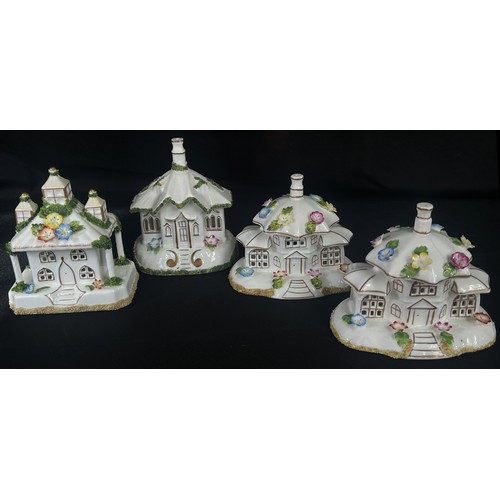 58 - A collection of four Coalport pastel burner cottages