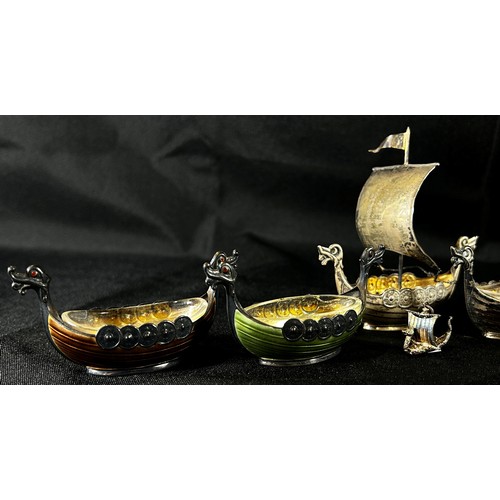 206 - Four Norwegian silver Viking ship salts, two are enamelled, a small silver model Viking ship in full... 