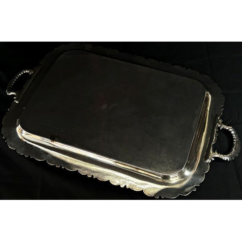 196 - A large late 19th century silver plated tray with scrolling floral garlands, 71cm handle to handle x... 