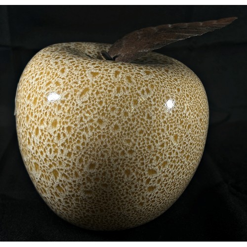 186 - A mottled glass apple with burnished metal leaf 15cm approximately high,