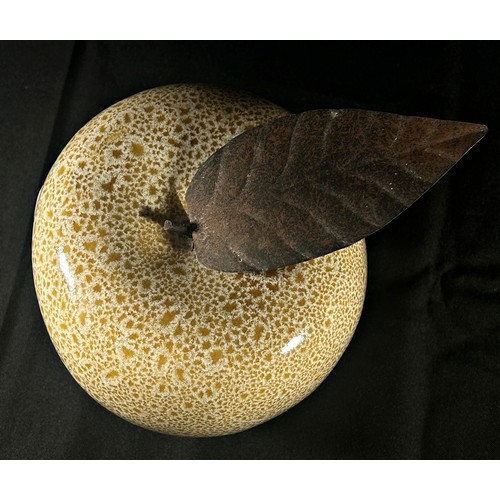 186 - A mottled glass apple with burnished metal leaf 15cm approximately high,