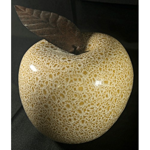 186 - A mottled glass apple with burnished metal leaf 15cm approximately high,