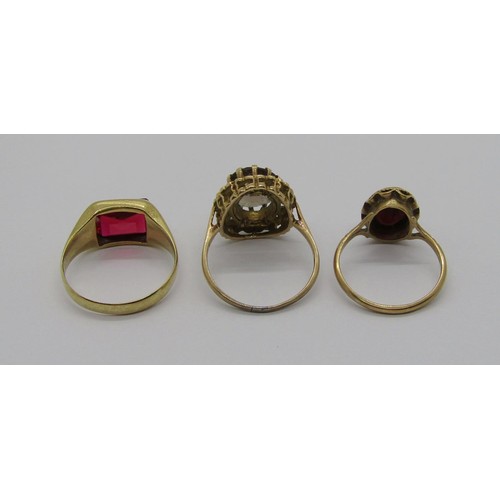 233 - Three vintage gem set gold rings; a 10k scissor-cut synthetic ruby example, size R, and two 9ct exam... 