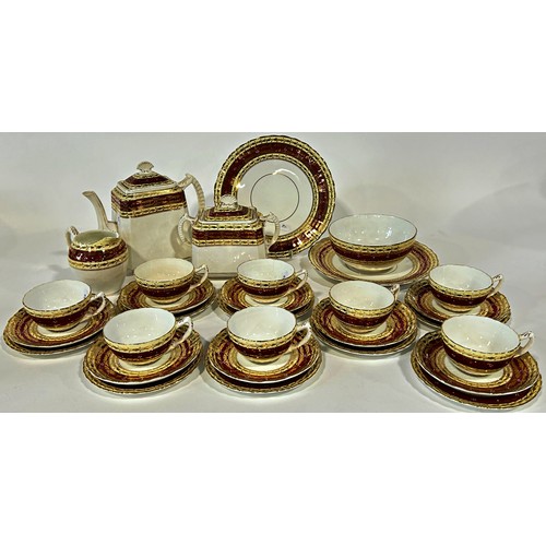 65 - A late 19th century English tea service with red and gilt banded detail, for twelve