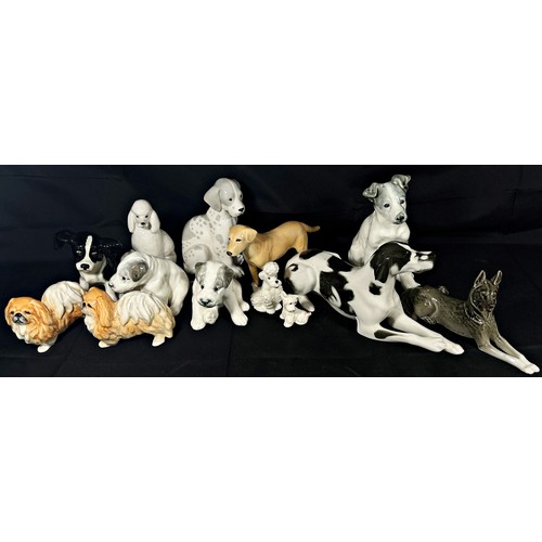 33 - Thirteen mostly Russian dog figures including poodle, Pekinese, German Shepherd, etc