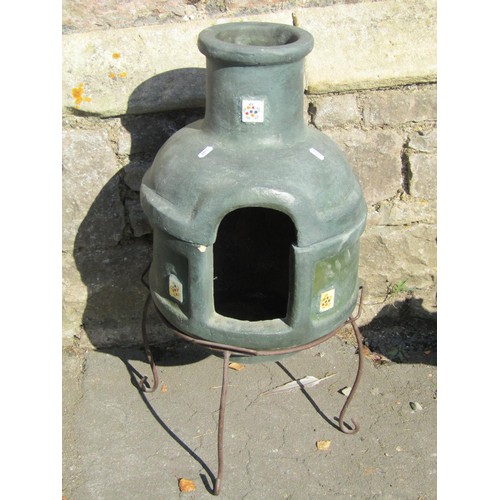 1010 - A small painted two sectional clay chimenea raised on aa simple iron stand, 72cm high