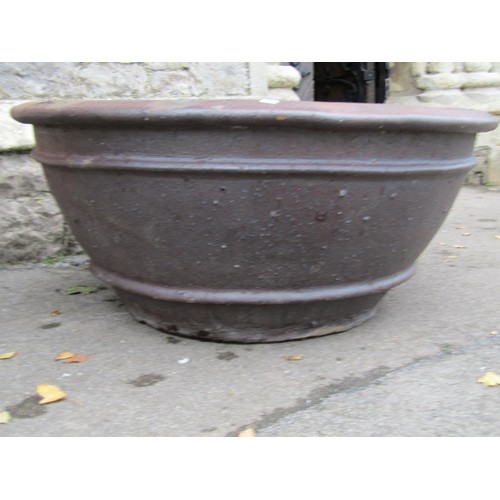 1032 - A large matt glazed terracotta planter of circular tapered ribbed for 44cm high x 100cm diameter, to... 