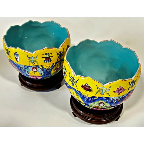 76 - A pair of Chinese lotus bowls, each decorated with figures and auspicious symbols, with apocryphal r... 