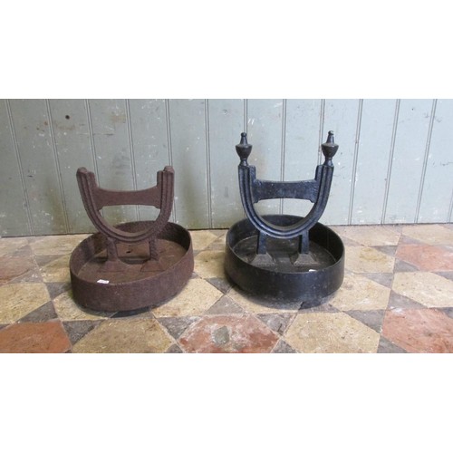 1058 - A pair of cast iron Victorian boot scrapers raised/set in oval tray bases, (af one painted, the othe... 