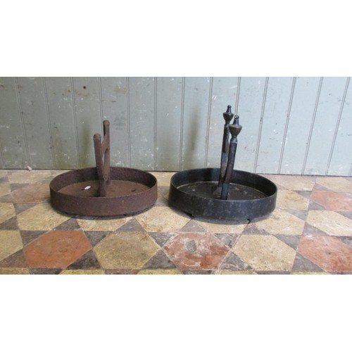 1058 - A pair of cast iron Victorian boot scrapers raised/set in oval tray bases, (af one painted, the othe... 