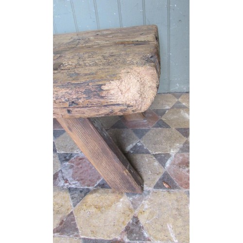 1057 - An antique pine pig bench with through jointed splayed legs, 36cm high x 138cm long x 56cm wide