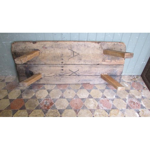 1057 - An antique pine pig bench with through jointed splayed legs, 36cm high x 138cm long x 56cm wide