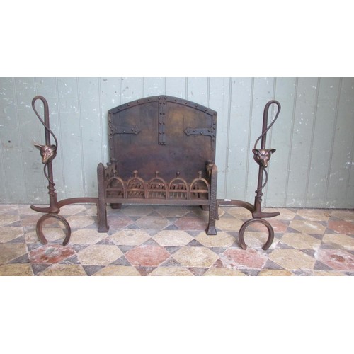 1045 - An unusual cast iron fire basket with pierced stirrup grate beneath an arched old English style back... 