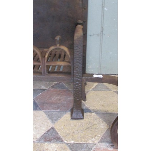 1045 - An unusual cast iron fire basket with pierced stirrup grate beneath an arched old English style back... 