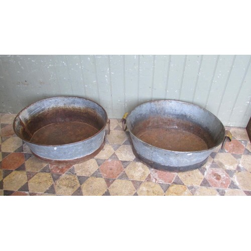 1060 - Two similar vintage weathered oval zinc and cast iron bath planters with loose drop ring handles, 25... 