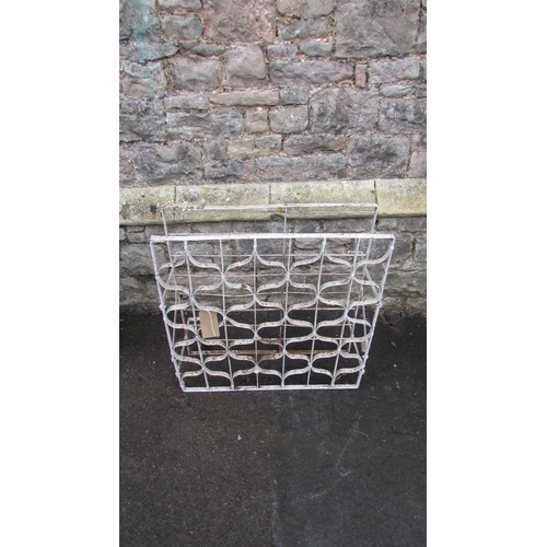 1044 - A vintage painted iron wine rack with bound whiplash divisions, 75cm high x 72cm wide x 30cm deep