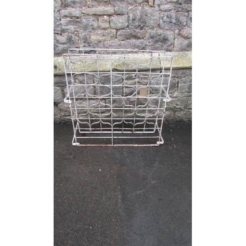 1044 - A vintage painted iron wine rack with bound whiplash divisions, 75cm high x 72cm wide x 30cm deep