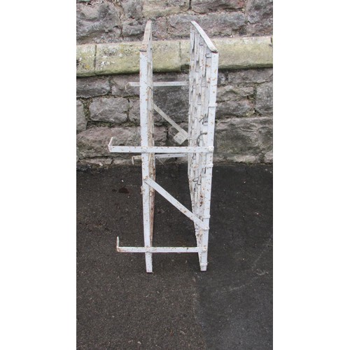 1044 - A vintage painted iron wine rack with bound whiplash divisions, 75cm high x 72cm wide x 30cm deep