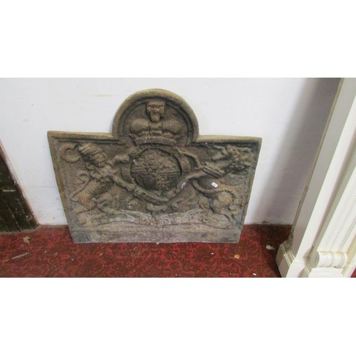 1078 - An old English style cast iron fireback of stepped arched form, with raised armorial shield, flanked... 