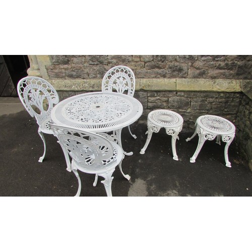 1009 - A cream painted cast aluminium garden terrace table of circular form with decorative pierced radiati... 