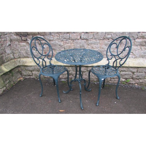 1003 - A decorative three piece painted cast aluminium garden terrace set with open and pierced scrolled de... 